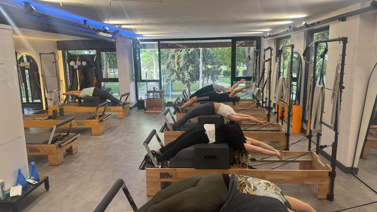 Grup reformer dersinde tayt ve tişörtle çalışan üyeler